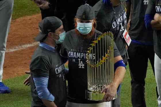 CPLos Angeles Dodgers third baseman Justin Turner celebrates with the trophy after defeating the Tampa Bay Rays 3-1 to win the baseball World Series in Game 6 Tuesday, in Arlington, Texas. (SUE OGROCKI / THE ASSOCIATED PRESS)