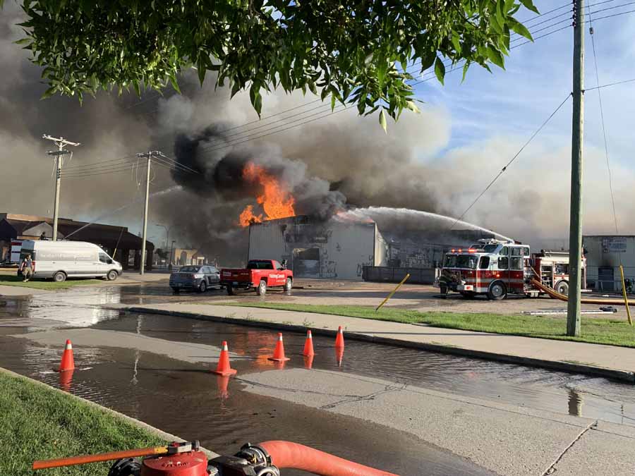 Fire and smoke rise from a building in Steinbach on Sunday. (Robin Maier photo)