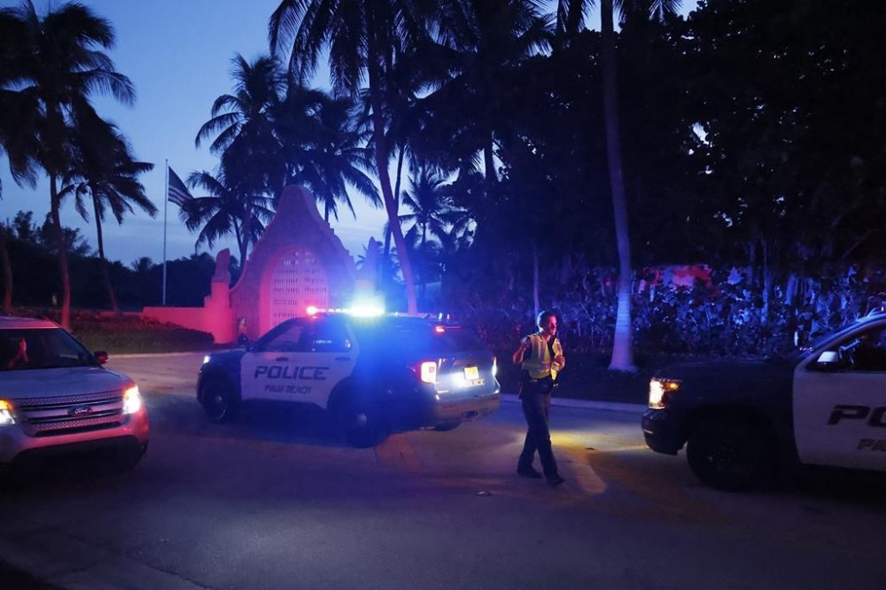 Police direct traffic outside an entrance to former President Donald Trump's Mar-a-Lago estate, Monday, Aug. 8, 2022, in Palm Beach, Fla. Trump said in a lengthy statement that the FBI was conducting a search of his Mar-a-Lago estate and asserted that agents had broken open a safe. (AP Photo/Terry Renna)