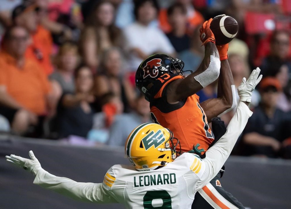 B.C. Lions' Dominique Rhymes, back, makes a touchdown reception in the end zone as Edmonton Elks' Raphael Leonard defends during the first half of CFL football game in Vancouver, on Saturday, August 6, 2022.Quarterback Nathan Rourke and receiver Rhymes, both of the Lions, and defensive back Titus Wall of the Calgary Stampeders were named the top performers for Week 9 of the CFL season Tuesday. THE CANADIAN PRESS/Darryl Dyck