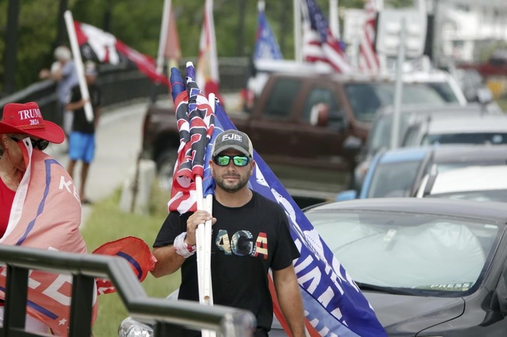 Supporters of former President Donald Trump walk down Southern Blvd., Tuesday, Aug. 9, 2022, to protest the FBI raid at Mara-Lago in Palm Beach Monday. (Joe Cavaretta/South Florida Sun-Sentinel via AP)
