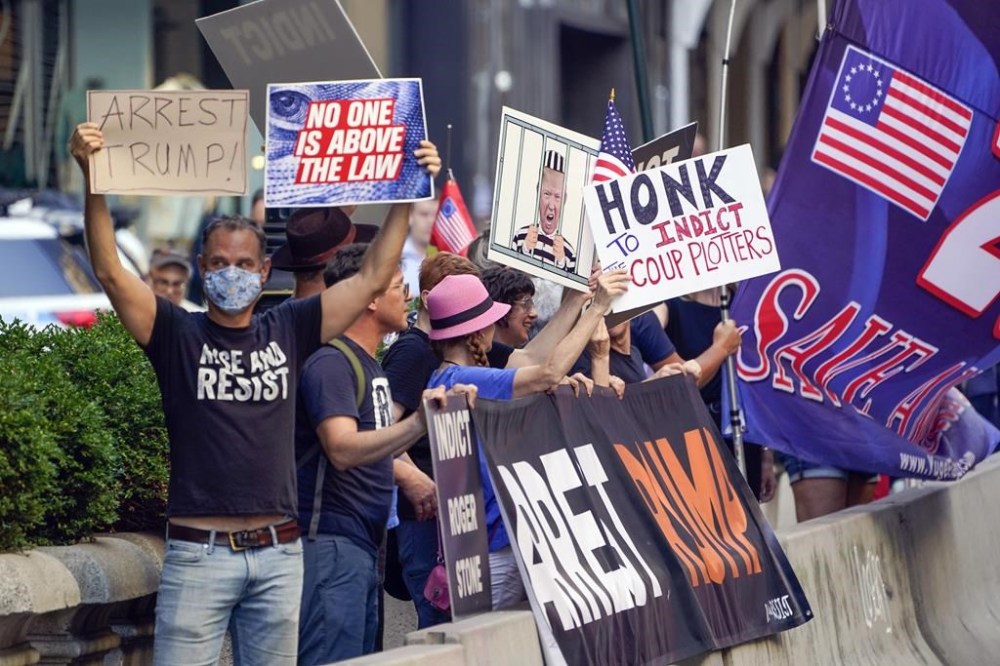 Protesters stand in front of Trump Tower in New York, Tuesday, Aug. 9, 2022. The FBI search of Donald Trump's Mar-a-Lago estate marked a dramatic and unprecedented escalation of the law enforcement scrutiny of the former president, but the Florida operation was just one part of one investigation related to Trump and his time in office. (AP Photo/Seth Wenig)