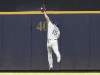 Milwaukee Brewers center fielder Tyrone Taylor (15) makes a catch on a ball hit by Tampa Bay Rays' David Peralta during the first inning of a baseball game Wednesday, Aug. 10, 2022, in Milwaukee. (AP Photo/Jeffrey Phelps)