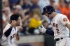 Houston Astros' Alex Bregman (2) celebrates with Jose Altuve after hitting a two-run home run against the Texas Rangers during the fifth inning of a baseball game Thursday, Aug. 11, 2022, in Houston. (AP Photo/David J. Phillip)