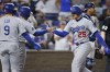 Los Angeles Dodgers' Gavin Lux (9) and Max Muncy, second from left, congratulate Trayce Thompson (25) at home plate after Thompson hit a three-run home run during the eighth inning of a baseball game against the Kansas City Royals in Kansas City, Mo., Friday, Aug. 12, 2022. (AP Photo/Colin E. Braley)