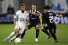 FILE - Marseille's Konrad De La Fuente, left, fights for the ball with Qarabag's Marko Vesovic, center, and Qarabag's Kady, right, during the Europa League Group E soccer match between Marseille and FK Qarabag at the Velodrome stadium in Marseille, France, Thursday, Feb. 17, 2022. American forward Konrad de la Fuente has joined Greek club Olympiakos on a season-long loan from Marseille. (AP Photo/Daniel Cole, File)