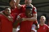 Nottingham Forest's Taiwo Awoniyi, center, celebrates with his teammates after scoring against West Ham during the English Premier League soccer match between Nottingham Forest and West Ham United at the City ground in Nottingham, England, Sunday, Aug. 14, 2022. (AP Photo/Rui Vieira)
