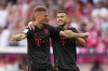 Bayern's Joshua Kimmich and Lucas Hernandez, right, celebrate their side's second goal during the German Bundesliga soccer match between FC Bayern Munich and VfL Wolfsburg in Munich, Germany, Sunday, Aug. 14, 2022. (AP Photo/Matthias Schrader)
