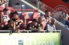 Manchester United's head coach Erik ten Hag, at right in grey, watches his team plays from the dug out during the English Premier League soccer match between Brentford and Manchester United at the Gtech Community Stadium in London, Saturday, Aug. 13, 2022. (AP Photo/Ian Walton)