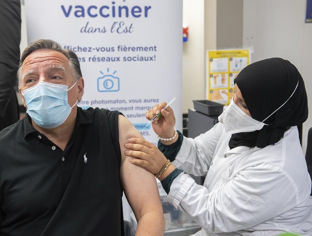 Quebec has begun offering a fifth dose of vaccine against COVID-19 for residents of long-term care homes and private senior residences. Quebec Premier François Legault receives a COVID-19 booster vaccine dose from Kenza Kias in Montreal, Friday, Aug. 5, 2022. THE CANADIAN PRESS/Graham Hughes