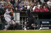 Chicago White Sox's Josh Harrison, right, and Houston Astros catcher Martin Maldonado watch Harrison's inning-ending popup during the seventh inning of a baseball game Monday, Aug. 15, 2022, in Chicago. (AP Photo/Charles Rex Arbogast)