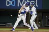 Texas Rangers' Brad Miller connects for a single against the Oakland Athletics during the fourth inning of a baseball game in Arlington, Texas, Monday, Aug. 15, 2022. (AP Photo/Tony Gutierrez)