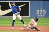 Toronto Blue Jays shortstop Bo Bichette, left, throws to first base to put out Baltimore Orioles' Anthony Santander after forcing out Adley Rutschman, right, in ninth inning American League baseball action in Toronto on Monday, August 15, 2022. THE CANADIAN PRESS/Jon Blacker