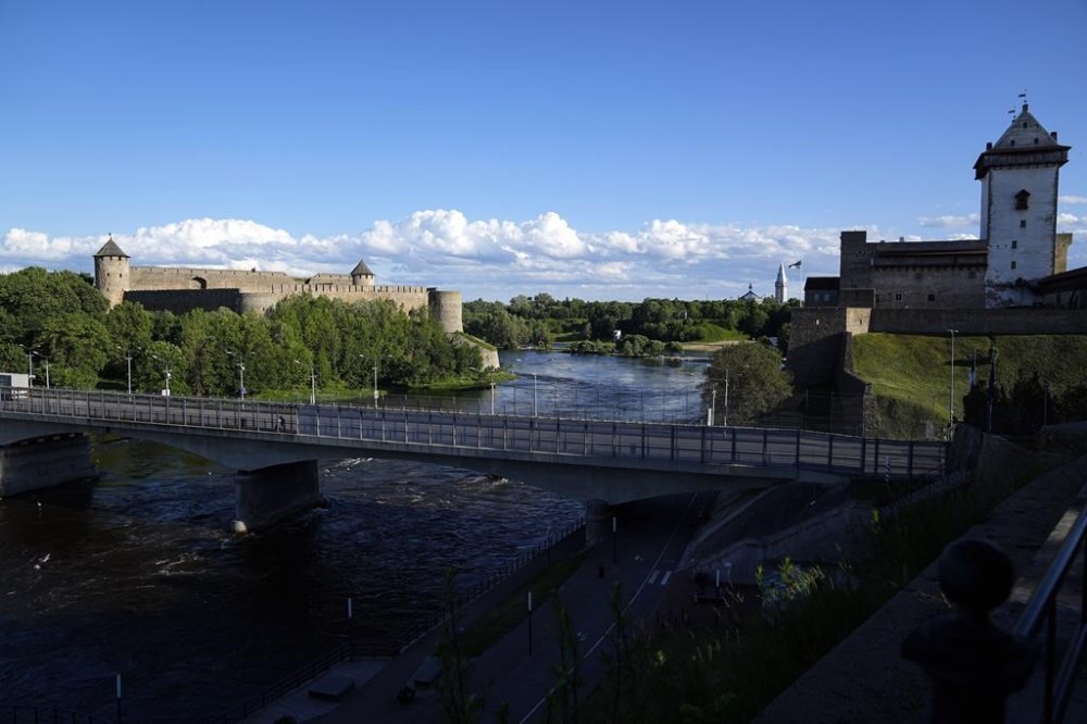 FILE - A bridge straddles Ivangorod, Russia, left, and a border crossing in Narva, Estonia, Thursday, June 16, 2022. Estonia's government said Tuesday Aug. 16, 2022, that it has decided to remove a Soviet monument in this town sitting in the Baltic country's Russian-speaking part, with the prime minister saying the reason for the dismantling is that it represents a risk for public order. (AP Photo, File)