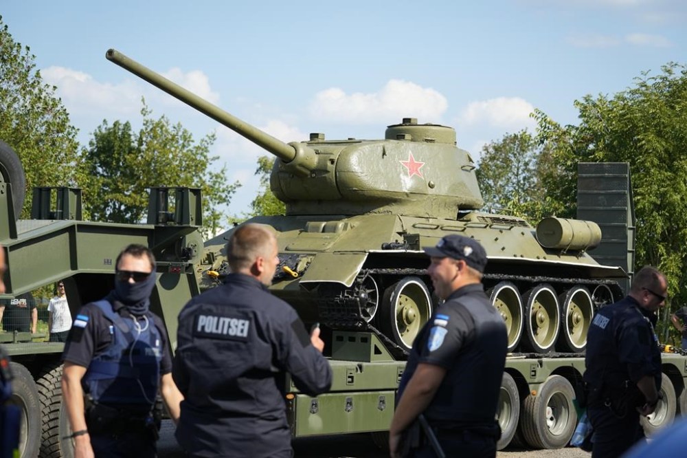 Police officers stand next to a trailer transporting a Soviet T-34 tank which was installed as a monument in Narva, arrived to a military museum in Tallinn, Estonia, Tuesday, Aug. 16, 2022. Estonia's government said Tuesday it has decided to remove a Soviet monument in the border town of Narva, sitting in the Baltic country's Russian-speaking part, with the prime minister saying the reason for the dismantling is that it represents a risk for public order. (AP Photo/Sergei Grits)