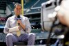 Los Angeles Dodgers television reporter David Vassegh works on a pregame broadcast before a baseball game against the Milwaukee Brewers Thursday, Aug. 18, 2022, in Milwaukee. Vassegh said he broke two bones in his right wrist and cracked six ribs Wednesday when he tumbled and crashed into the padding at the end of his slide down 
