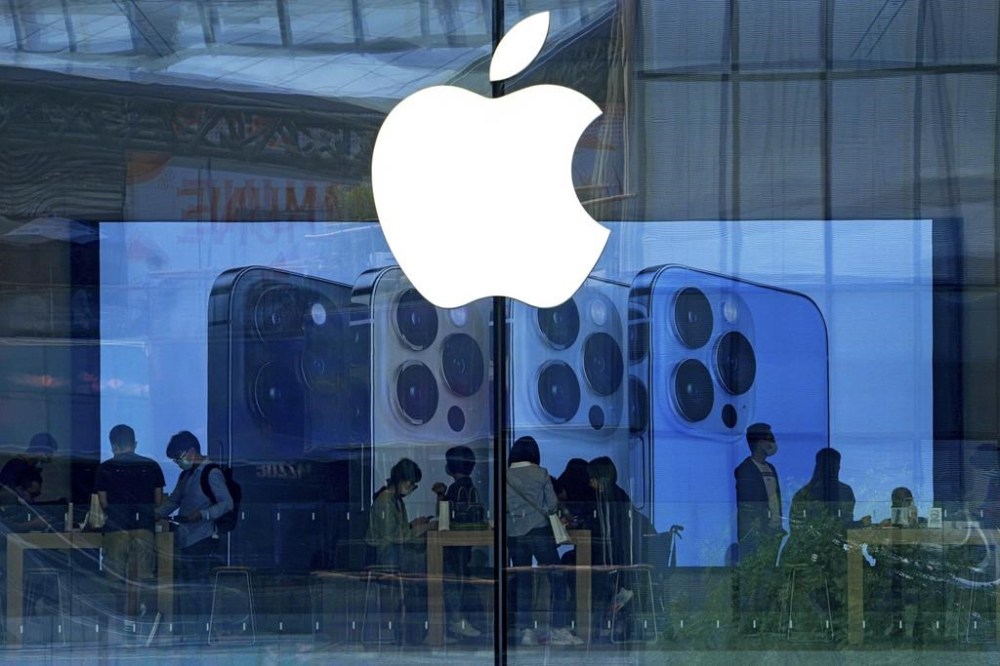 FILE - People shop at an Apple Store in Beijing, Tuesday, Sept. 28, 2021. Apple disclosed serious security vulnerabilities Wednesday, Aug. 17, 2022 for iPhones, iPads and Macs. The software flaws could potentially allow attackers to take complete control of these devices, Apple said. (AP Photo/Andy Wong, File)
