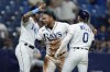 Tampa Bay Rays' Harold Ramirez, center, celebrates with David Peralta, left, and Taylor Walls on a two-run single by Randy Arozarena off Kansas City Royals starting pitcher Brady Singer during the sixth inning of a baseball game Friday, Aug. 19, 2022, in St. Petersburg, Fla. (AP Photo/Chris O'Meara)