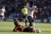 Bournemouth's Jordan Zemura, left, fouls Arsenal's Bukayo Saka, for which he received a yellow card, during the English Premier League soccer match at the Vitality Stadium, Bournemouth, England, Saturday Aug. 20, 2022. (Steven Paston/PA via AP)