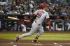 St. Louis Cardinals' Nolan Arenado hits an RBI-single against the Arizona Diamondbacks in the first inning during a baseball game, Sunday, Aug. 21, 2022, in Phoenix. (AP Photo/Rick Scuteri)