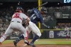 Washington Nationals catcher Riley Adams, left puts an insurance tag on Seattle Mariners' Julio Rodriguez (44) after Rodriguez struck out swinging during the fifth inning of a baseball game, Tuesday, Aug. 23, 2022 in Seattle. (AP Photo/Ted S. Warren)