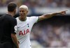 Tottenham's Richarlison, right, discusses with referee Anthony Taylor during the English Premier League soccer match between Chelsea and Tottenham Hotspur at Stamford Bridge Stadium in London, Sunday, Aug. 14, 2022. (AP Photo/Ian Walton)