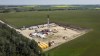 An oil drilling rig operates surrounded by canola and hay fields near Cremona, Alta., Monday, July 12, 2021.THE CANADIAN PRESS/Jeff McIntosh