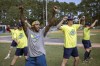 FILE - Savannah Bananas first base coach Maceo Harrison, foreground, teaches a dance routine to members of the team before they play the Florence Flamingos, Tuesday, June 7, 2022, in Savannah, Ga. The Savannah Bananas, who became a national sensation with their irreverent style of baseball, are leaving the Coastal Plains League to focus full attention on their professional barnstorming team. Owner Jesse Cole made the announcement in a YouTube video, saying “we'll be able to bring the Savannah Bananas to more people in Savannah and around the world.