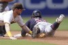 San Diego Padres second baseman Jake Cronenworth, left, is late with the tag as Cleveland Guardians' Josh Naylor safely steals second base during the fourth inning of a baseball game Wednesday, Aug. 24, 2022, in San Diego. (AP Photo/Gregory Bull)