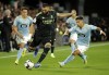 Real Madrid's Karim Benzema, center, kicks the ball during a Spanish La Liga soccer match between Celta Vigo and Real Madrid at the Balaidos stadium in Vigo, Spain, Saturday, Aug. 20, 2022. (AP Photo/Lalo R. Villar)