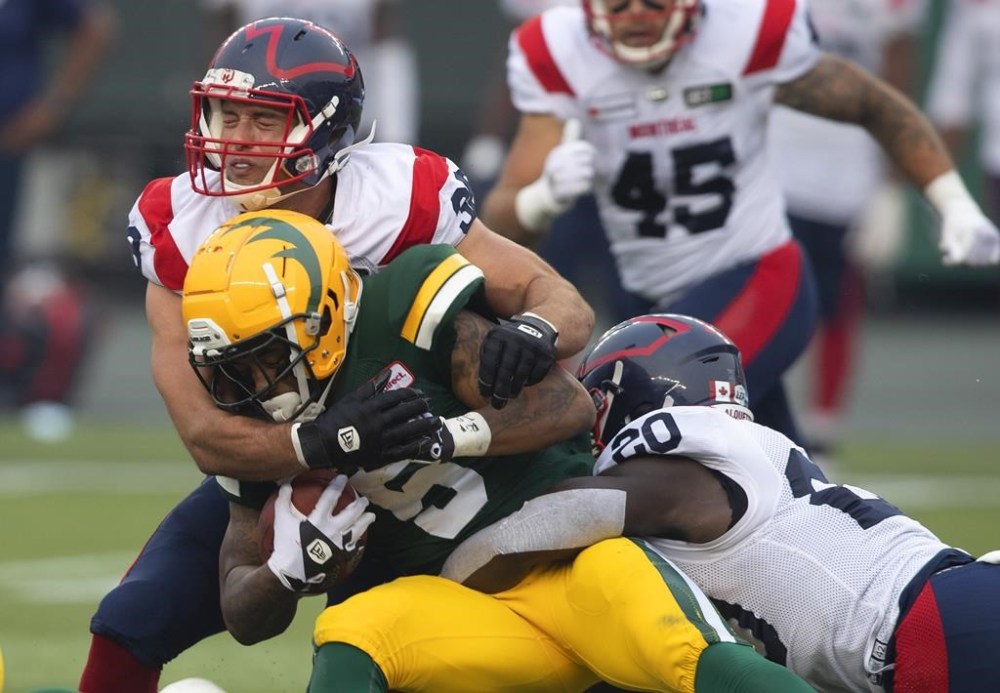 The Montreal Alouettes say player Christophe Normand has been suspended pending the outcome of a luring investigation. Normand (38) and Jeshrun Antwi (20) tackle Edmonton Elks' Terry Williams (5) during CFL action in Edmonton, Alta., on Saturday August 14, 2021. THE CANADIAN PRESS/Jason Franson.