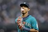 Seattle Mariners' Julio Rodriguez blows a bubble as he runs to the dugout while leaving the field during the second inning of a baseball game against the Cleveland Guardians, Friday, Aug. 26, 2022, in Seattle. (AP Photo/John Froschauer)