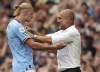 Manchester City's Erling Haaland celebrates scoring his side fourth goal of the game to complete his hat trick with manager Pep Guardiola during the Premier League match at the Etihad Stadium, Manchester, England, Saturday Aug. 27, 2022. (Nick Potts/PA via AP)