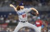 Los Angeles Dodgers starting pitcher Dustin May delivers during the first inning of a baseball game against the Miami Marlins, Saturday night, Aug. 27, 2022 in Miami. (AP Photo/Michael Laughlin)