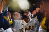 Milwaukee Brewers' Christian Yelich is congratulated after hitting a three-run home run during the seventh inning of a baseball game against the Chicago Cubs Saturday, Aug. 27, 2022, in Milwaukee. (AP Photo/Morry Gash)