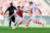 Cologne's Jan Thielmann, center, and Luca Kilian and Stuttgart's Silas Katompa Mvuumpa, left, vie for the ball during the Bundesliga match between FC Cologne and VfB Stuttgart at the RheinEnergieStadion in Cologne, Germany, Sunday, Aug. 26, 2022. (Rolf Vennenbernd/dpa via AP)