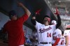Washington Nationals' Ildemaro Vargas (14) celebrates his home run in the dugout during the fifth inning of a baseball game against the Cincinnati Reds, Sunday, Aug. 28, 2022, in Washington. (AP Photo/Nick Wass)