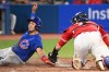 Toronto Blue Jays catcher Danny Jansen, left, tags out Chicago Cubs' Nick Madrigal at home plate in fifth inning interleague baseball action in Toronto on Monday, Aug. 29, 2022. THE CANADIAN PRESS/Jon Blacker