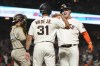 San Francisco Giants' Joc Pederson, right, celebrates after hitting a two-run home run that scored LaMonte Wade Jr. (31) as San Diego Padres catcher Austin Nola, left, looks on during the fourth inning of a baseball game in San Francisco, Monday, Aug. 29, 2022. (AP Photo/Jeff Chiu)