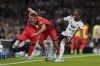 Fulham's Bobby Decordova-Reid tackles Brighton and Hove Albion's Leandro Trossard during the English Premier League soccer match between Fulham and Brighton at Craven Cottage, London, Tuesday Aug. 30, 2022. (John Walton/PA via AP)