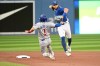 Toronto Blue Jays shortstop Bo Bichette, right, throws to first base to complete a double play on Chicago Cubs' Willson Contreras after forcing out Nick Madrigal (1) at second base in first inning interleague baseball action in Toronto on Tuesday, August 30, 2022. THE CANADIAN PRESS/Jon Blacker