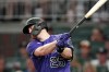 Colorado Rockies' C.J. Cron drives in a run with a base hit during the fourth inning of the team's baseball game against the Atlanta Braves on Tuesday, Aug. 30, 2022, in Atlanta. (AP Photo/John Bazemore)