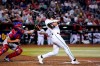 Arizona Diamondbacks' Jake McCarthy, watches his three-run home run next to Philadelphia Phillies catcher Garrett Stubbs during the fourth inning of a baseball game Tuesday, Aug. 30, 2022, in Phoenix. (AP Photo/Ross D. Franklin)