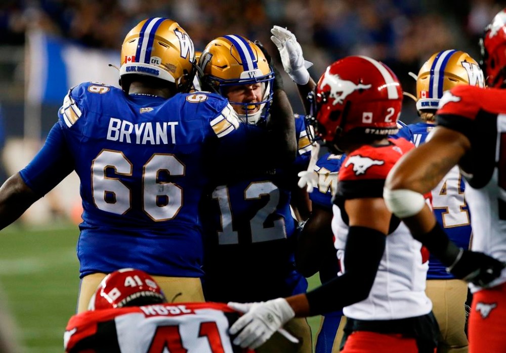 Winnipeg Blue Bombers quarterback Dakota Prukop (12) celebrates his game winning short yardage touchdown against the Calgary Stampeders during the second half CFL action in Winnipeg Thursday, August 25, 2022. THE CANADIAN PRESS/John Woods