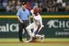 Texas Rangers' Marcus Semien steals second as umpire D.J. Reyburn looks on in the first inning of a baseball game against the Houston Astros in Arlington, Texas, Wednesday, Aug. 31, 2022. The steal was Semien's 20th of the season. (AP Photo/Tony Gutierrez)