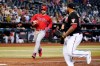 Philadelphia Phillies' Bryce Harper, left, heads home to score as Arizona Diamondbacks pitcher Reyes Moronta moves to back up the play during the fifth inning of a baseball game Wednesday, Aug. 31, 2022, in Phoenix. (AP Photo/Ross D. Franklin)
