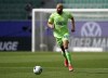 FILE - Wolfsburg's John Brooks plays the ball during the team's German Bundesliga soccer match against Bayern Munich in Wolfsburg, Germany, April 17, 2021. Brooks signed a one-year contract with the Portuguese club Benfica on Thursday, Sept. 1, 2022. The 29-year-old, who left Germany's Wolfsburg at the end of last season, hopes to play his way back into contention for a spot on the U.S. World Cup roster. (AP Photo/Michael Sohn, Pool, File)