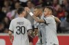 From left, PSG's Lionel Messi, PSG's Kylian Mbappe, and PSG's Neymar react after scoring a goal during the French League One soccer match between Lille and Paris Saint Germain at the Pierre Mauroy stadium in Villeneuve d'Ascq, northern France, Sunday, Aug. 21, 2022. (AP Photo/Michel Spingler)
