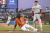 San Francisco Giants' Brandon Crawford (35) scores from third on a wild pitch by Philadelphia Phillies starting pitcher Kyle Gibson, right, during the first inning of a baseball game in San Francisco, Friday, Sept. 2, 2022. (AP Photo/Godofredo A. Vásquez)