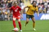 Janine Beckie, left, of Canada battles fort the ball with Emily Gielnik of Australia during the women's soccer friendly between Australia and Canada at Suncorp Stadium in Brisbane, Australia, Saturday, Sept. 3, 2022. (Darren England/AAP Image via AP)